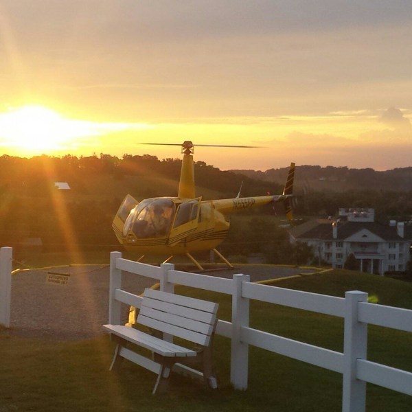 a sunset over a fence
