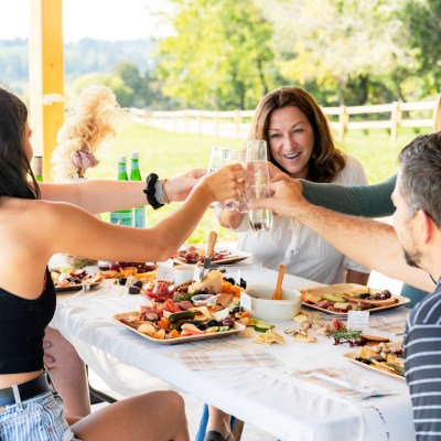 a group of people sitting at a table eating food
