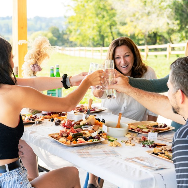 a group of people sitting at a table eating food
